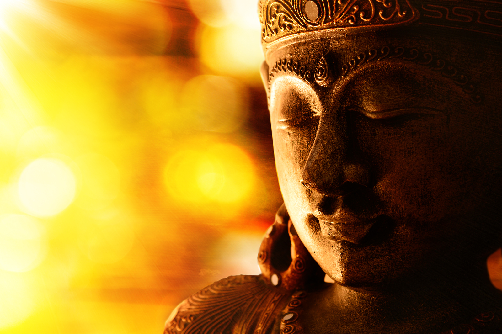 bronze buddha statue, orange background and copy space