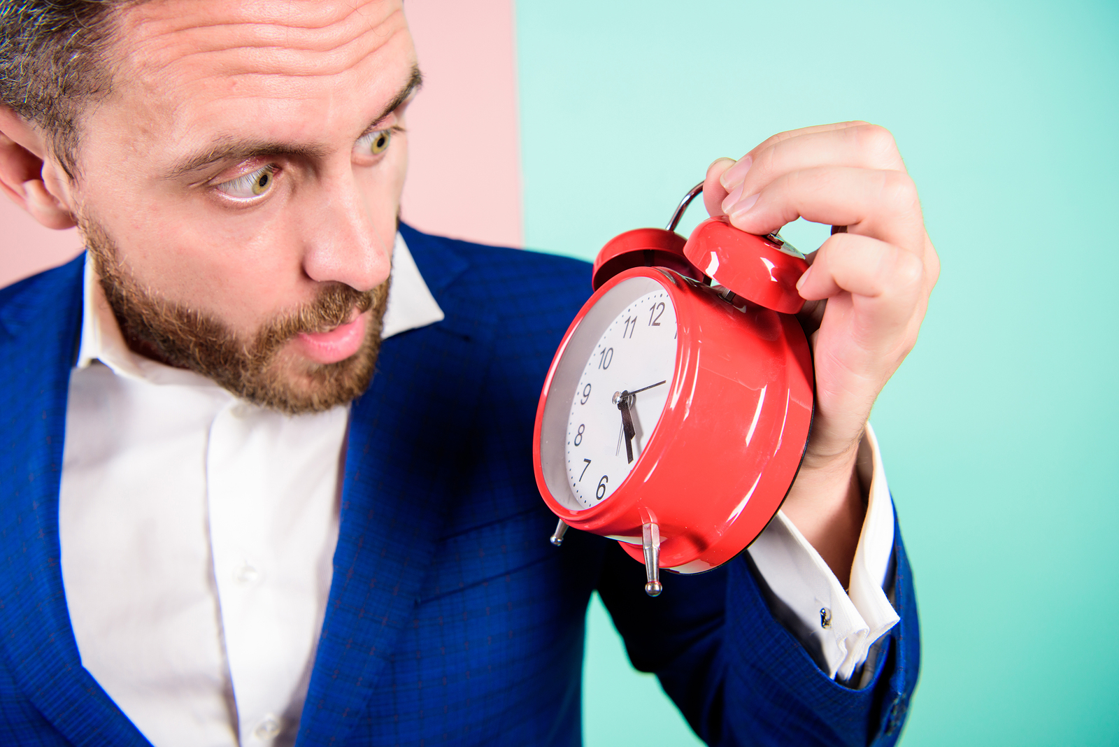 Businessman has lack of time. Time management skills. How much time left till deadline. Time to work. Man bearded surprised businessman hold clock. Stress concept. Mature man with wondering